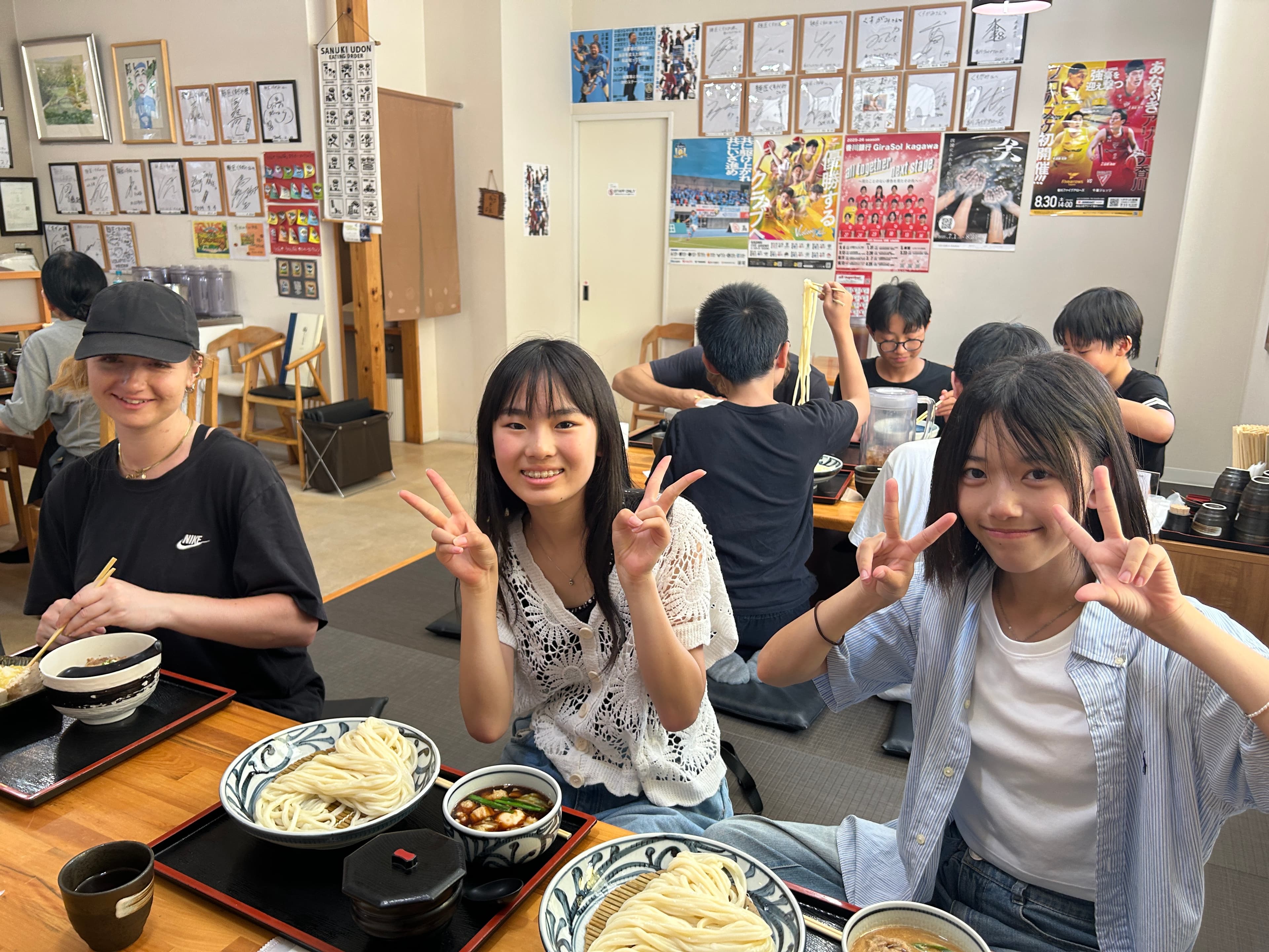 Students enjoying bowls of Sanuki udon at a local restaurant