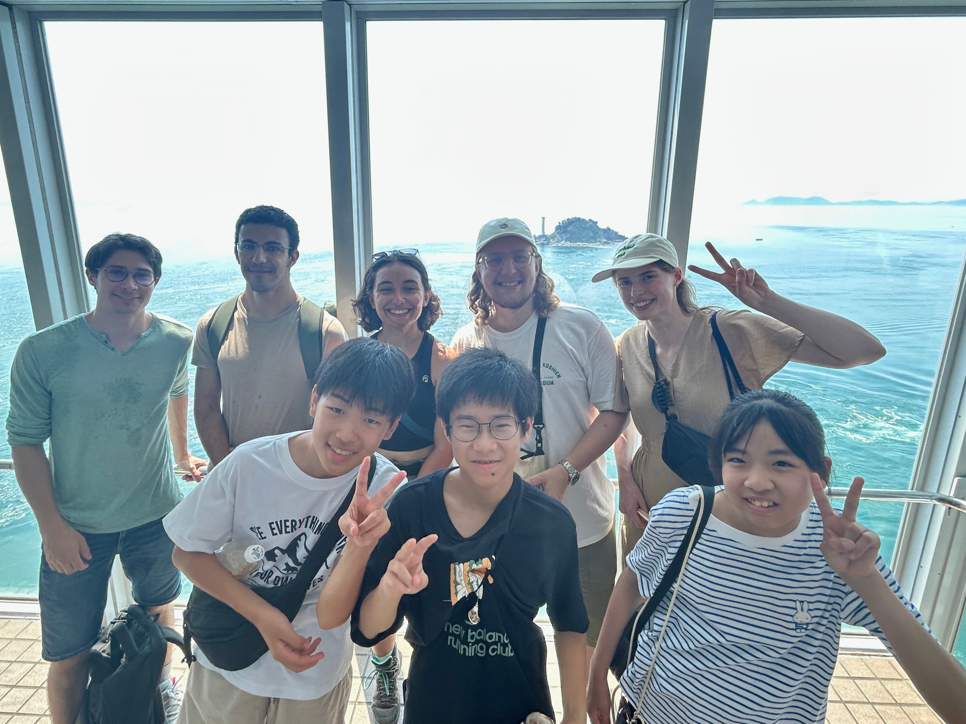 International and Japanese students together, the Seto Inland Sea behind them